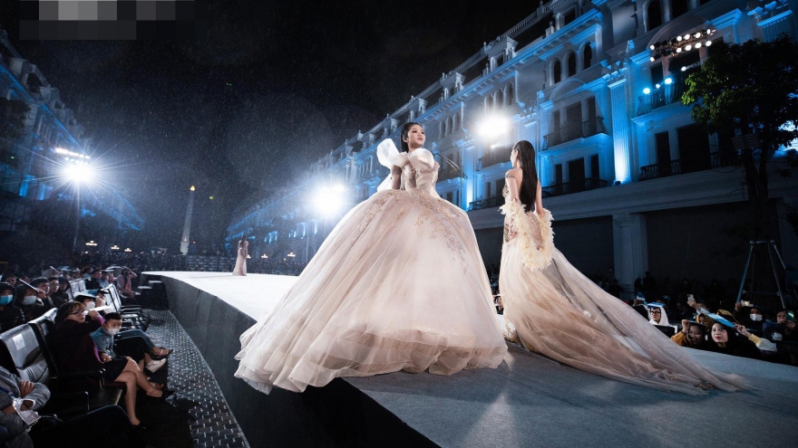 Miss World Vietnam contestants strut down the catwalk in the rain